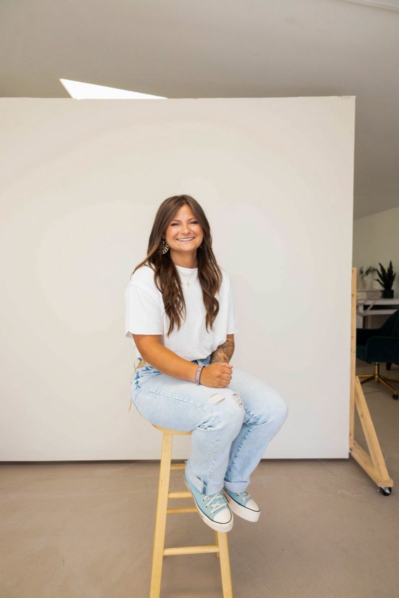 Morgan sitting on a stool in the studio