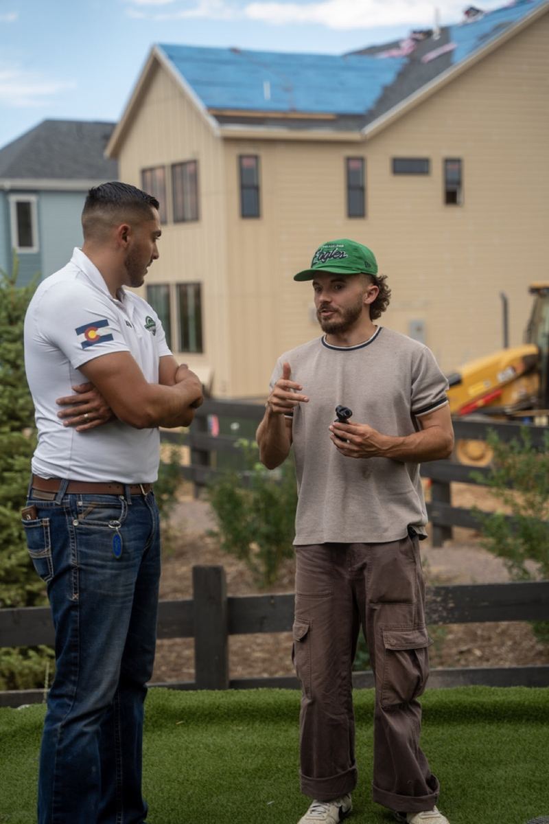 Andrew talking with a client on a job site