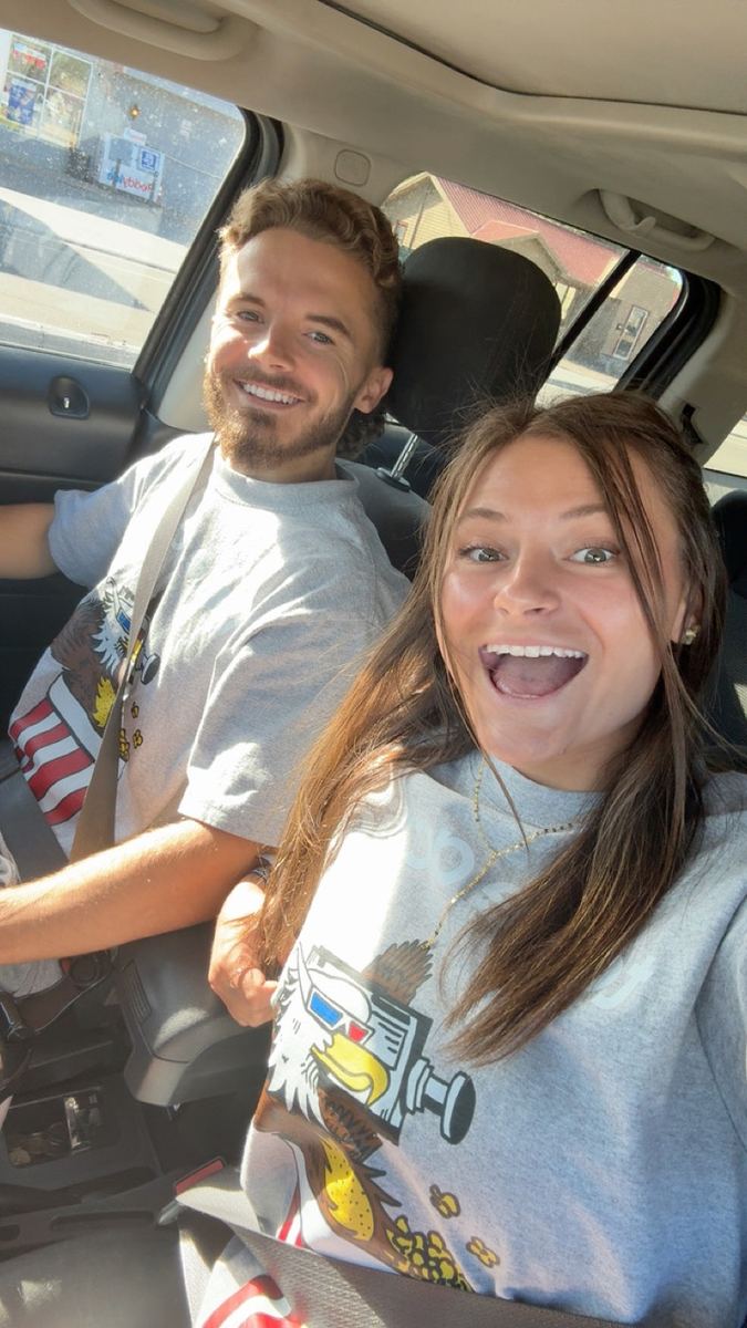 Andrew and Morgan in the car wearing Dollarmoovies shirts
